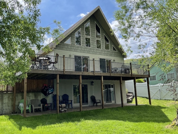 A two-story house with a balcony and a covered porch area.