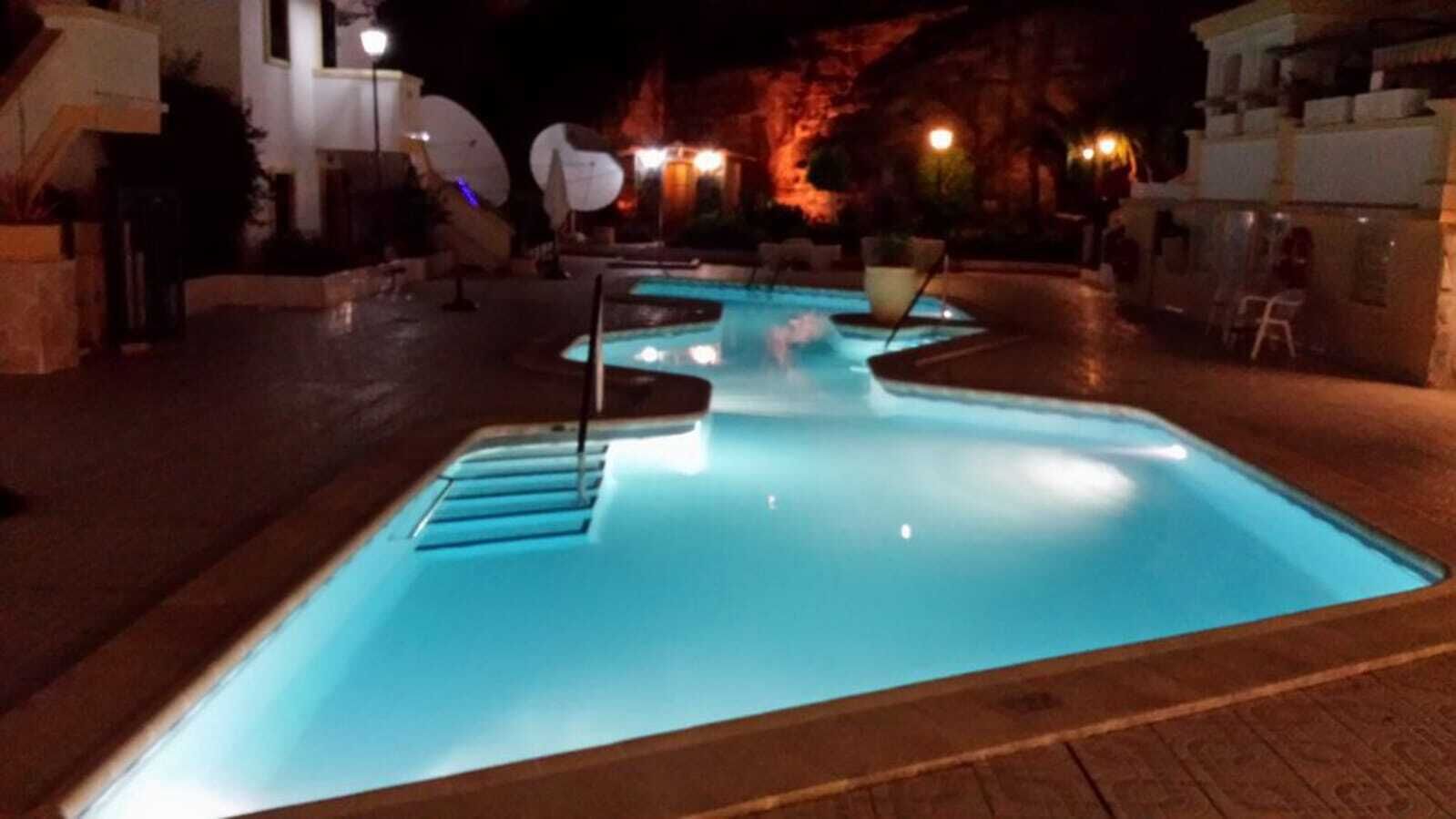 A heated pool, sun loungers