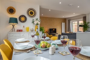 A dining area with a table set for two, featuring plates, cutlery, and glasses of red wine. - Little Soames, Holt, Norfolk (Holt)