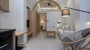A modern interior with a kitchen, dining area, and living space. - Marea Boutique Suites (Rethymno)