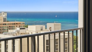 A view of a coastal cityscape with buildings and the ocean. - Tower 1 Suite 2705 - QQS (Honolulu)