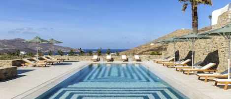Seasonal outdoor pool, open 8:00 AM to 9:00 AM, pool umbrellas