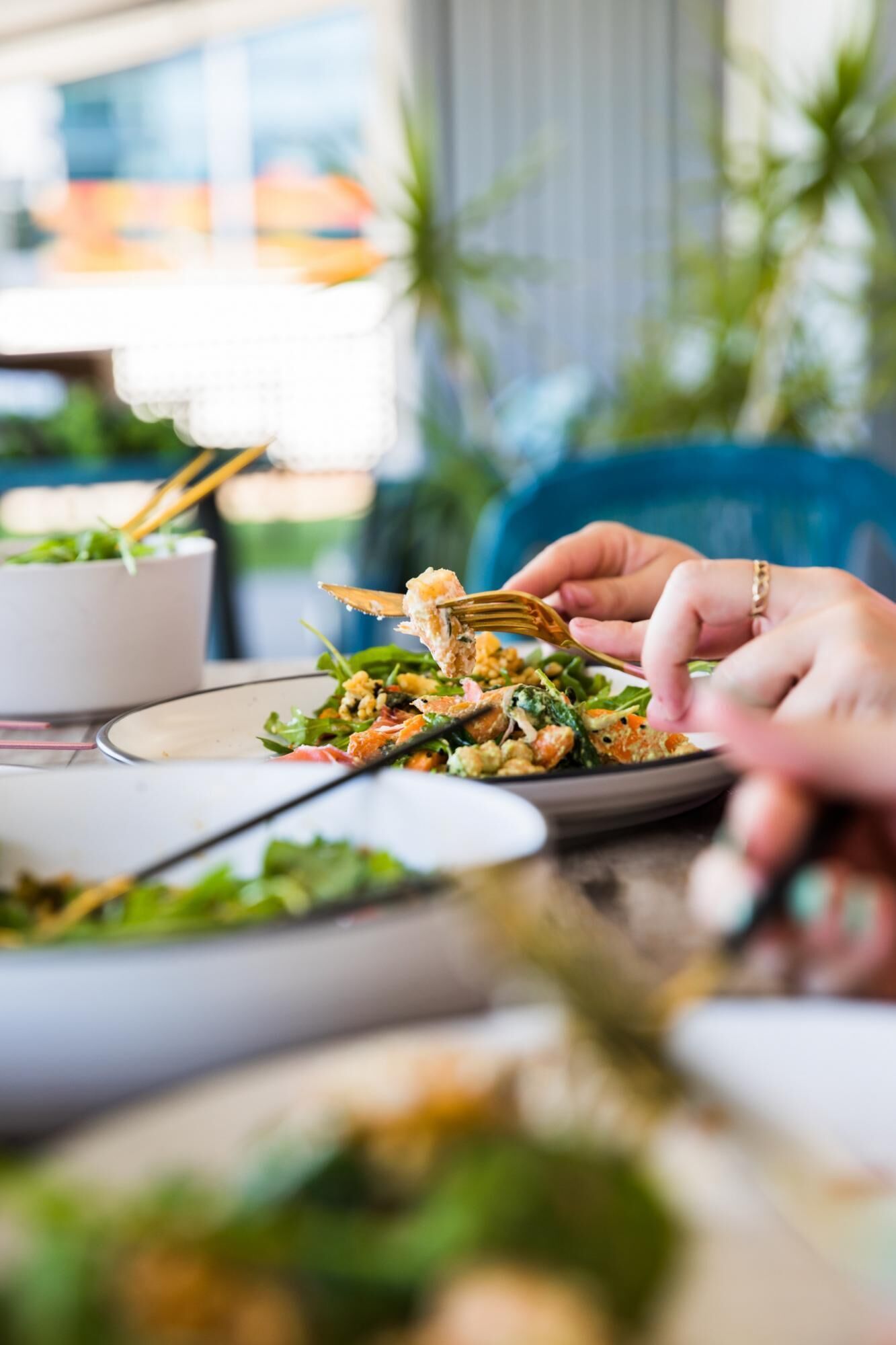 A person eating a salad with a fork.