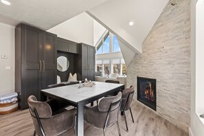 Enjoy cooking in this well-equipped kitchen with a central island, fireplace, and large window.