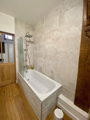 Bathtub, eco-friendly toiletries, hair dryer, towels