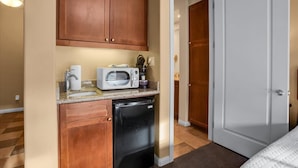 A compact kitchenette with a microwave, toaster, and refrigerator. - Mountain Vista C | Studio Legacy Villa (La Quinta)