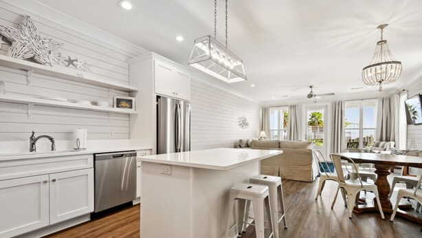 A modern kitchen with white cabinetry, stainless steel appliances, and a central island. - New 3 Bedroom Beachfront Rental in downtown Bay St Louis (Bay St. Louis)