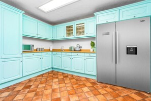 A kitchen with teal cabinets, a stainless steel refrigerator, and a tiled floor. - Stylish Three Bedroom House - Harborne - Parking - Garden (Harborne)