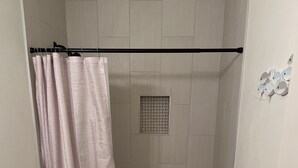 A bathroom with a toilet, shower, and vanity. - Hidden Bungalow 1 1/2 blocks from the beach (Bay St. Louis)