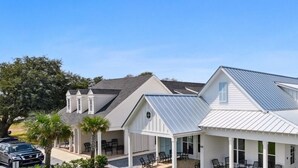 A row of white houses with metal roofs, each with a covered patio area. - New 2 Bedroom Beach Rental in downtown Bay St Louis (Bay St. Louis)