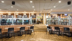A restaurant with booths, tables, and chairs.