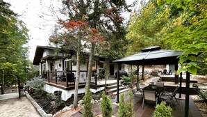 A modern house with a patio, outdoor seating, and a covered area. - Summer Getaway - 3 min walk to Beach, Clean & Cozy (Tiny)