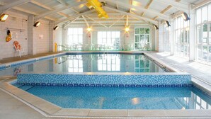 An indoor swimming pool with clear water, tiled walls, and overhead lighting. - The Mealhouse-UK12902 (Pelynt, near Looe)
