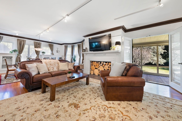 Spacious living room with open doors to screened-in porch.