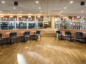 A restaurant with booths, tables, and chairs.