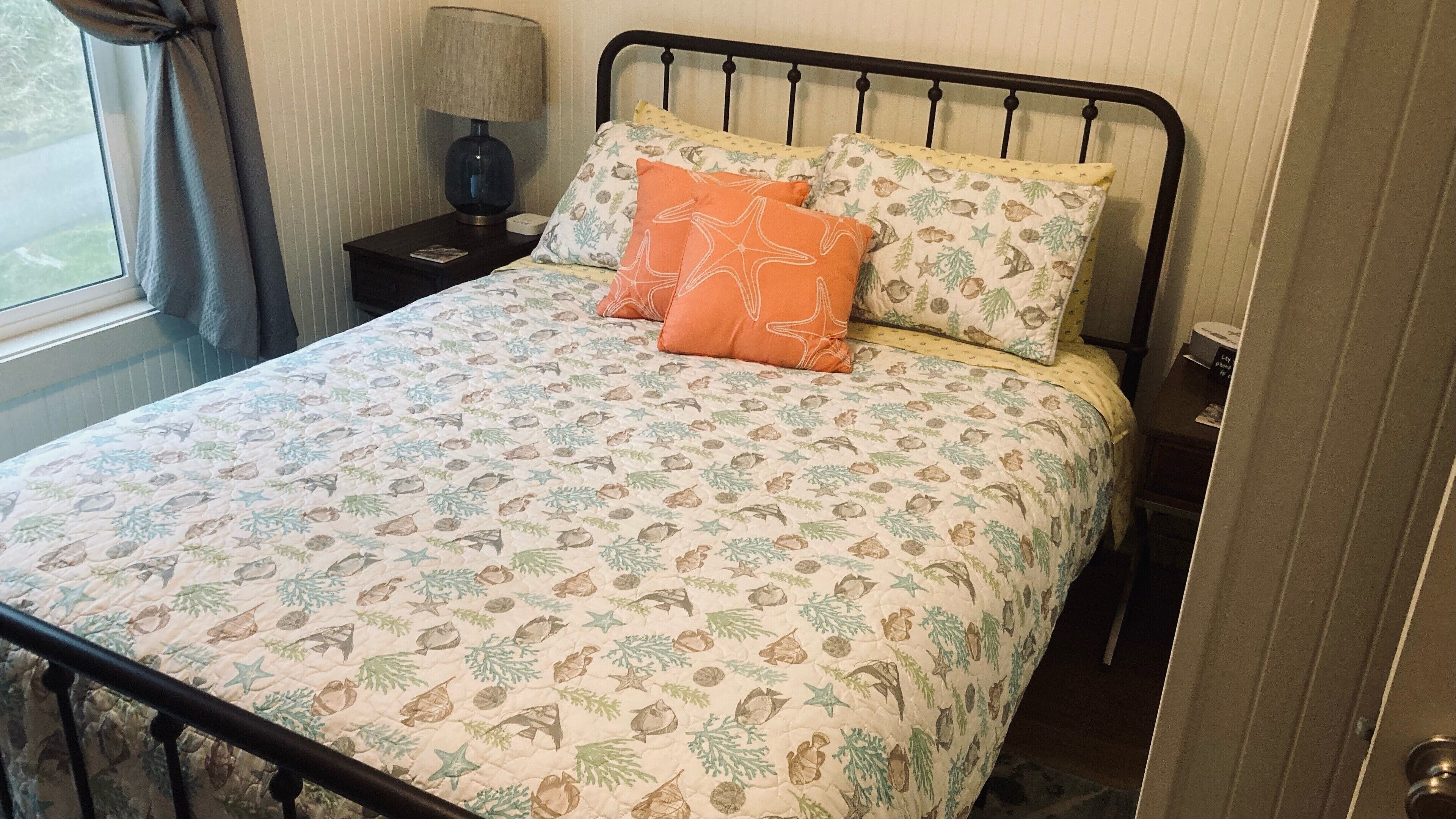 Private queen bedroom featuring premium bedding and serene beach house style.