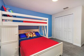 A bunk bed with a red mattress, a blue wall, and a white door. - 1upRetreat - Mario Private Pool Lazy River Disney (Davenport)