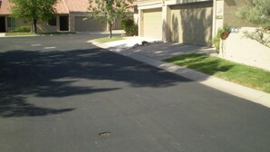 A residential street with houses, a clear driveway, and a well-maintained lawn. - Peaceful and tranquil townhouse for seniors  Heated pool/Spa gym. covered patio (Mesa)