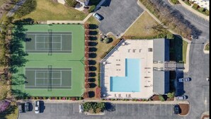 An aerial view of a facility with two tennis courts, a swimming pool, and a parking lot. - Condo in Legends Golf Course Resort  with a great Pub Next Door to the Unit (Myrtle Beach)