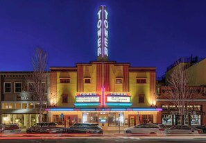 A theater with a marquee reading 'TOWER' and 'TOWER THEATER' with event listings. - Top Floor Riverfront Condo at the edge of Downtown (Bend)