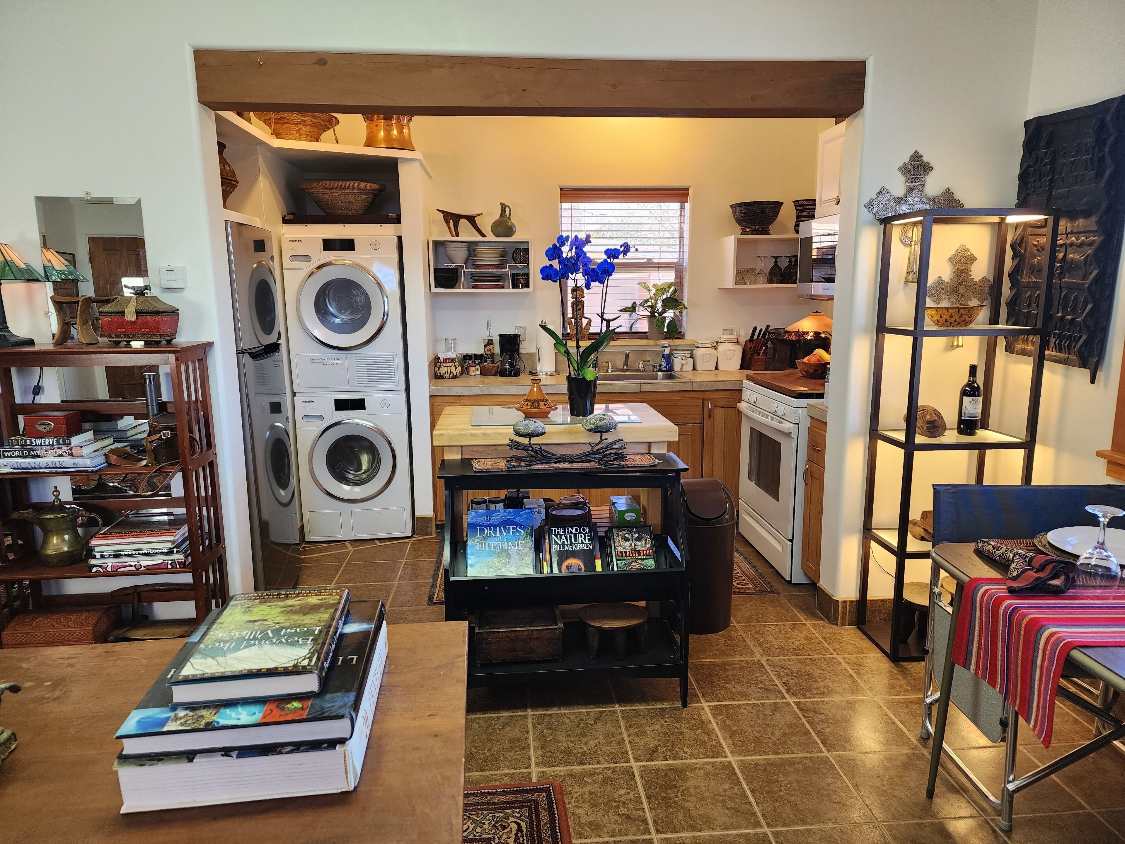 A compact living space with a kitchen, dining area, and laundry area.