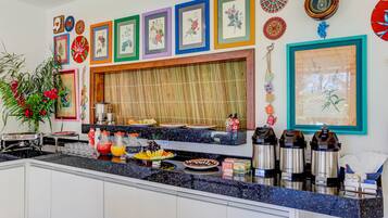 A kitchen with a buffet setup, including a variety of food items and a coffee station.