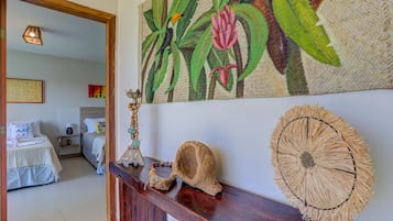Una habitación con una cama, una cesta tejida en la pared y un tapiz tejido en la pared.
