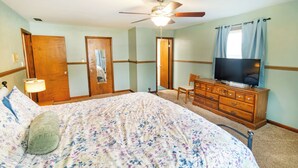 A bedroom with a bed, dresser, television, and a ceiling fan. - Comfort and Charm Highly Recommended (Newburgh)