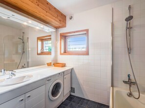Bathtub, hair dryer, towels, soap