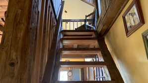 A wooden staircase leading to a second floor with a view of a room below. - Rustic two bedroom cottage on riverside in Shohola PA (Shohola)