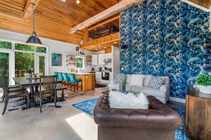 A modern kitchen with white cabinets, a wooden ceiling, and a hanging light fixture. - Elegant Birdhouse Cabin with 🔥Heated🔥 Cowboy Pool (Kyle)