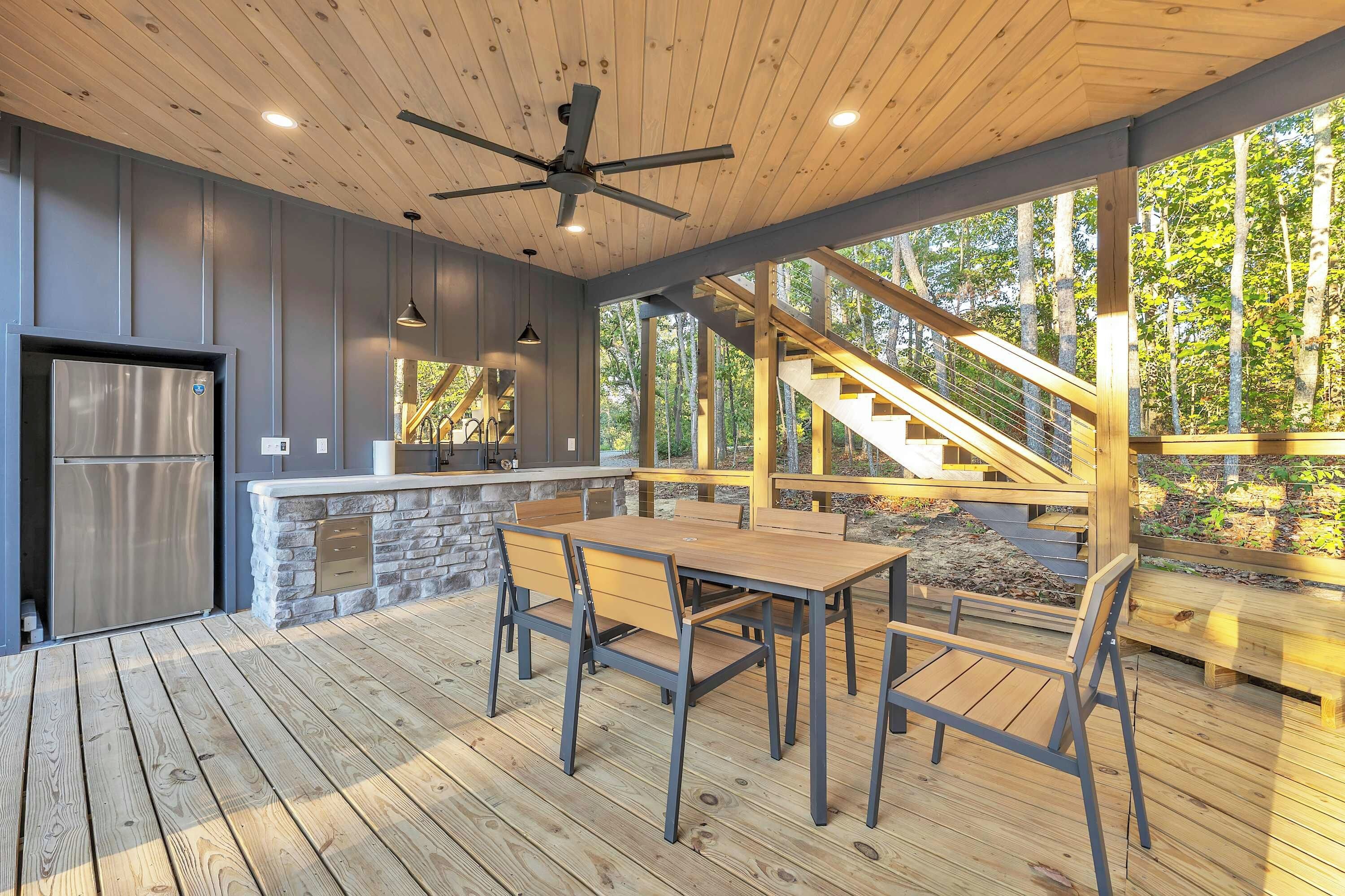 A modern kitchen with a stone countertop and a built-in refrigerator.