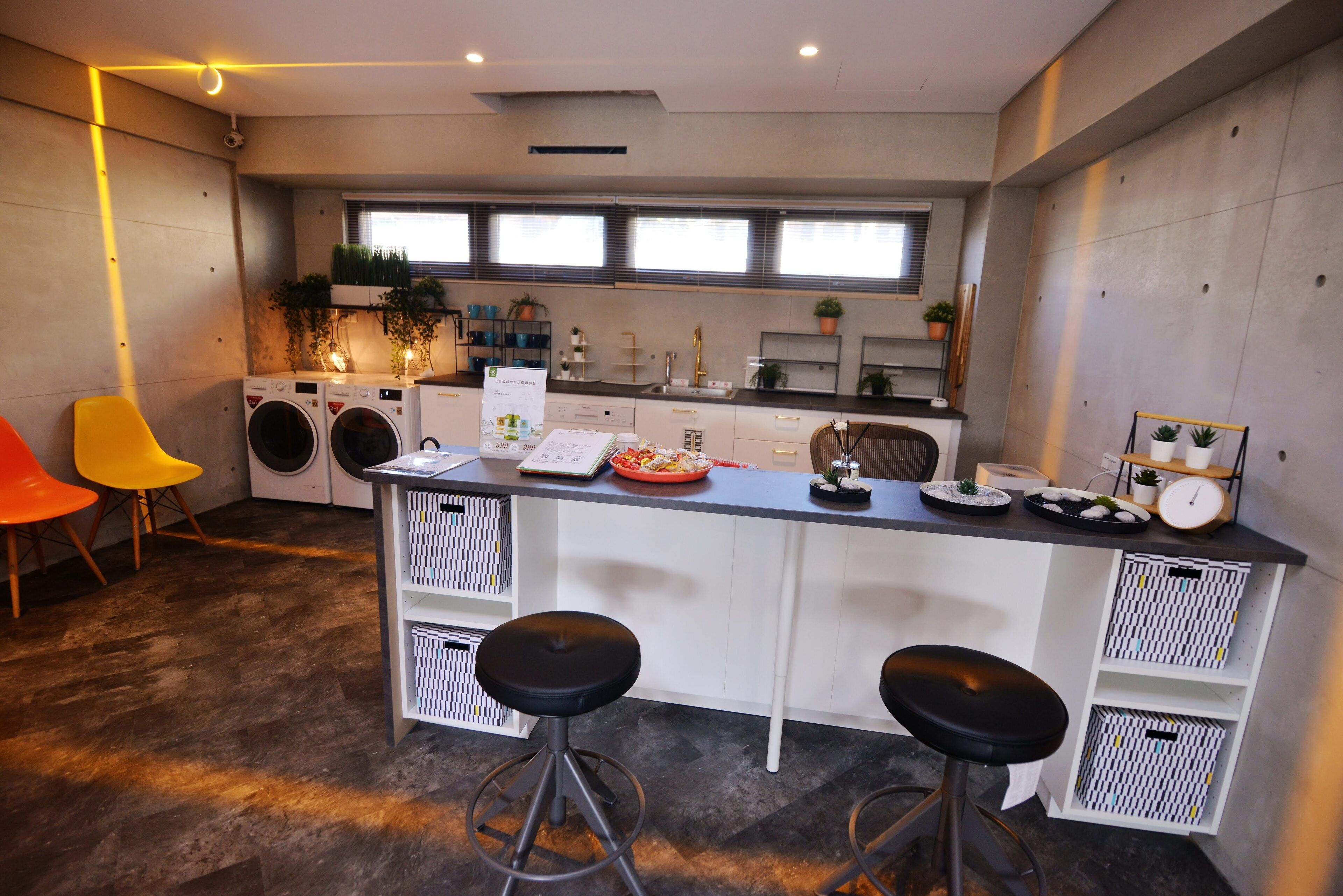 A compact kitchen with a central island, built-in appliances, and a seating area with stools.