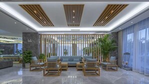 A modern lobby with a seating area, wooden partitions, and a large window. - Manyuegu Holiday Hotel (Xiangyun)
