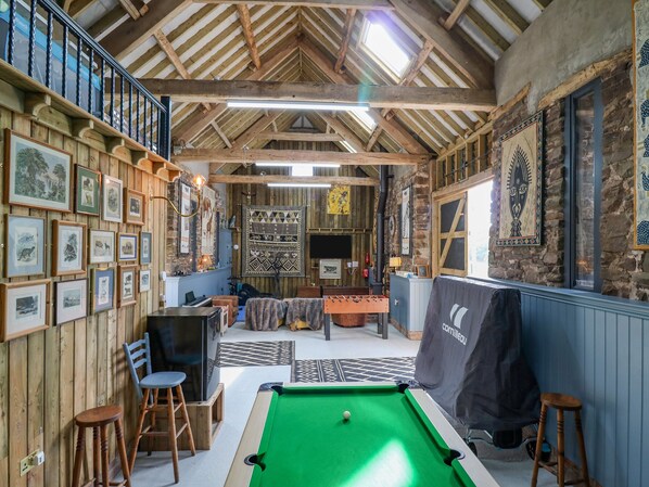 A cozy indoor space with a pool table, wooden walls, and various framed pictures. - Pen Bont Home Farm (Brecon)