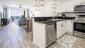 A modern kitchen with white cabinets, stainless steel appliances, and a central island. - Ariel Dunes I 1207 Beach Access*3 pools* (Miramar Beach)
