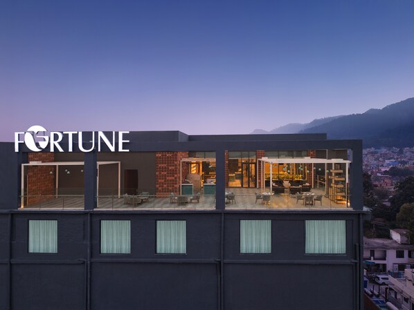 A modern building with a visible "FORTUNE" sign, large windows, and a terrace with outdoor seating. - Fortune Walkway Mall, Haldwani - Member ITC Hotels' Group (Haldwani)