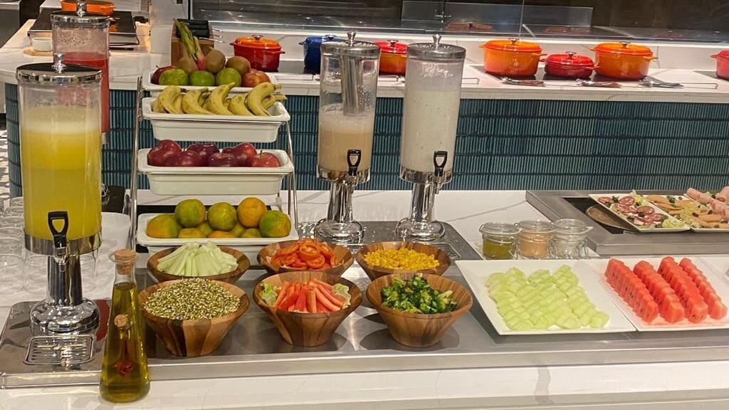 A buffet with various food items and beverages.