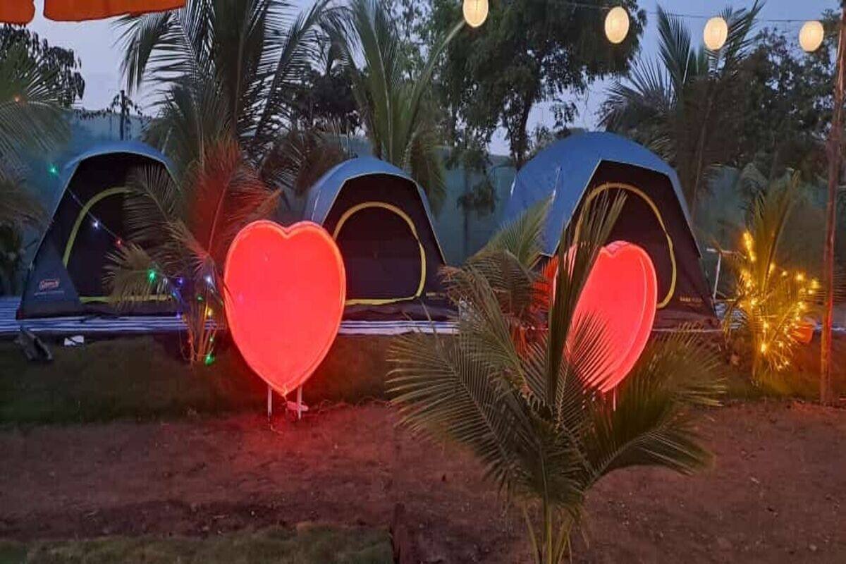 A row of tents with a prominent red heart-shaped object in the foreground.