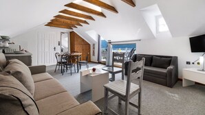 A modern loft apartment with a dining area, a sofa, a TV, and a view of the sea. - Apartment 'Chakalaka - Suite with Sea View' with Sea View, Wi-Fi and Air Conditioning (Leukada)