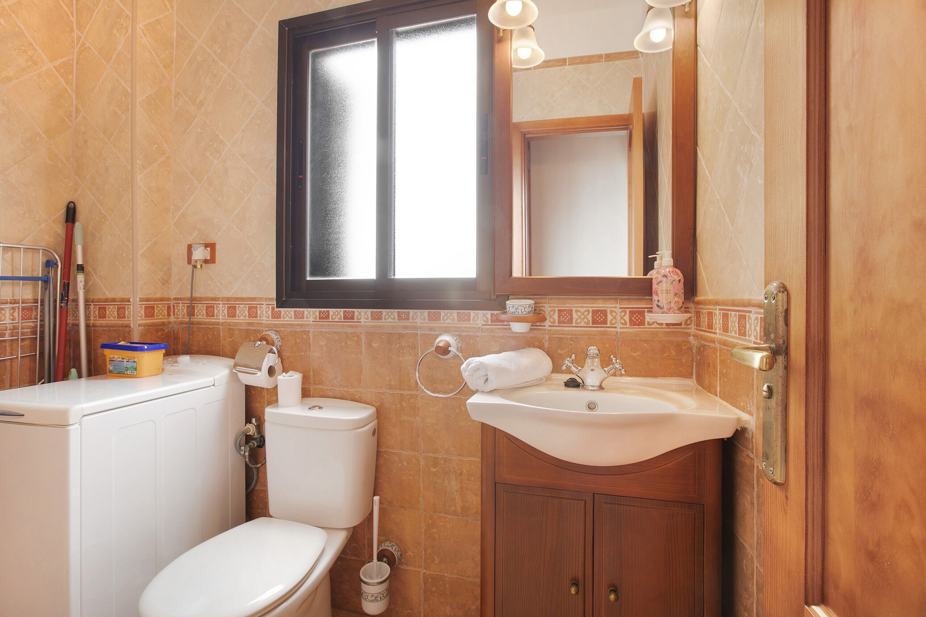 Un baño con inodoro, lavabo y espejo.