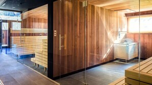 A modern interior with wooden panel walls, a glass partition, and a seating area with benches.