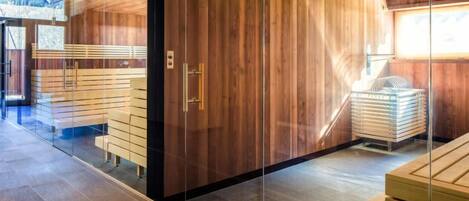 A modern interior with wooden panel walls, a glass partition, and a seating area with benches.