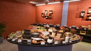 A buffet counter with various food items and a sign labeled "HEALTH SECTION".