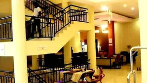 A multi-level interior with a staircase, seating area, and a reception desk. - Amor Hotel Ekiti (Ado Ekiti)