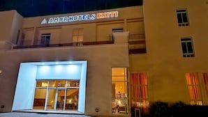 A hotel entrance with a sign reading "Amor Hotels Exit!" and a glass door leading into the building. - Amor Hotel Ekiti (Ado Ekiti)
