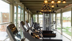 A gym with exercise equipment and large windows. - Razelm Luxury Resort (Jurilovca)
