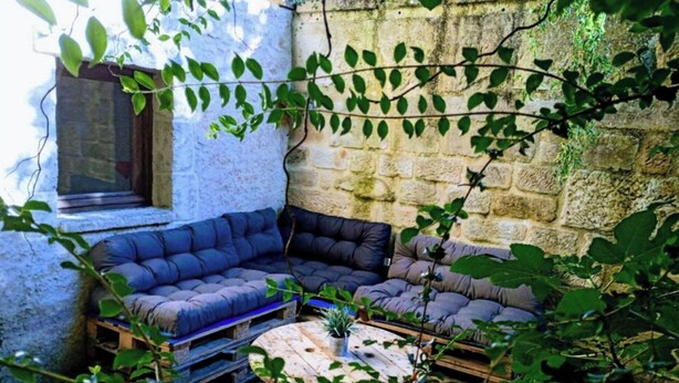 A cozy corner with a cushioned seating area, a small round table, and a window.