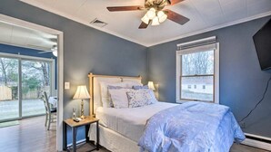A bedroom with a bed, a nightstand, a ceiling fan, and a window. - Homelike, peaceful and centrally- home located in the hamlet of Rocky  Point  NY (Rocky Point)
