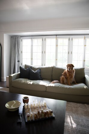 Relax in this inviting living room with a sofa, coffee table, and large window.